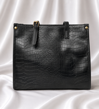 Luxury black crocodile-embossed women's tote bag with gold-tone hardware by Eisela.