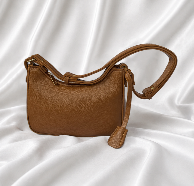 Eisela caramel brown pebbled crossbody bag with adjustable shoulder strap and gold-tone hardware.