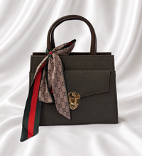 Espresso brown structured mini top handle handbag with gold-tone turn lock and decorative printed twilly scarf.