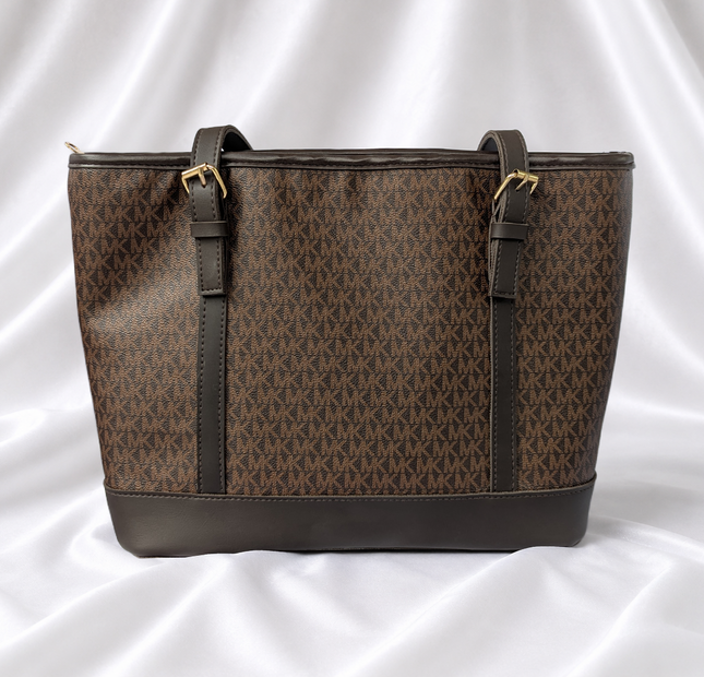 Brown women's monogram-inspired tote bag with dual shoulder straps and gold-tone buckle details.