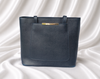 Eisela midnight blue women's structured tote bag with large front pocket, shoulder handles and gold-tone accent.
