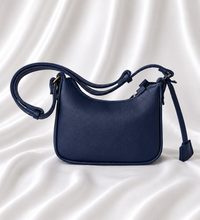 Eisela midnight navy pebbled crossbody bag with adjustable strap and gold-tone hardware.