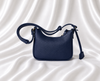 Eisela midnight navy pebbled crossbody bag with adjustable strap and gold-tone hardware.