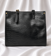 Luxury black crocodile-embossed women's tote bag with gold-tone hardware by Eisela.