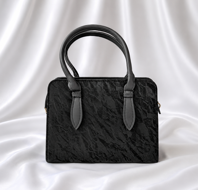 Black textured women's top handle handbag with structured design by Eisela.