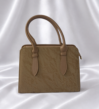 Luxury sandstone beige women's structured top handle handbag with textured finish by Eisela.