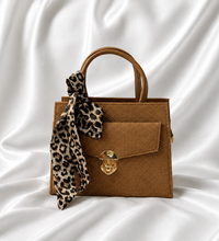 Camel brown structured mini top handle handbag with gold lock closure and leopard-print scarf by Eisela.