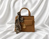 Camel brown structured mini top handle handbag with gold lock closure and leopard-print scarf by Eisela.