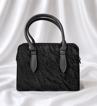 Black textured women's top handle handbag with structured design by Eisela.