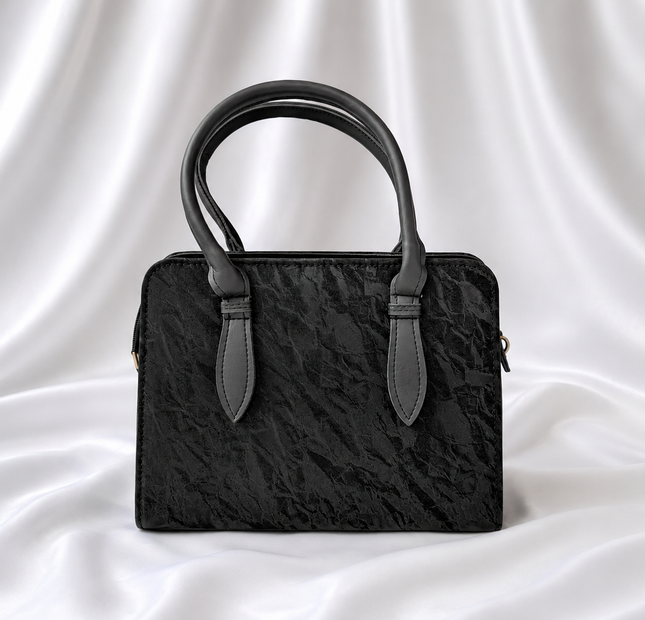 Black textured women's top handle handbag with structured design by Eisela.